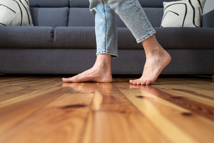 cropped shot of woman walking barefoot in room