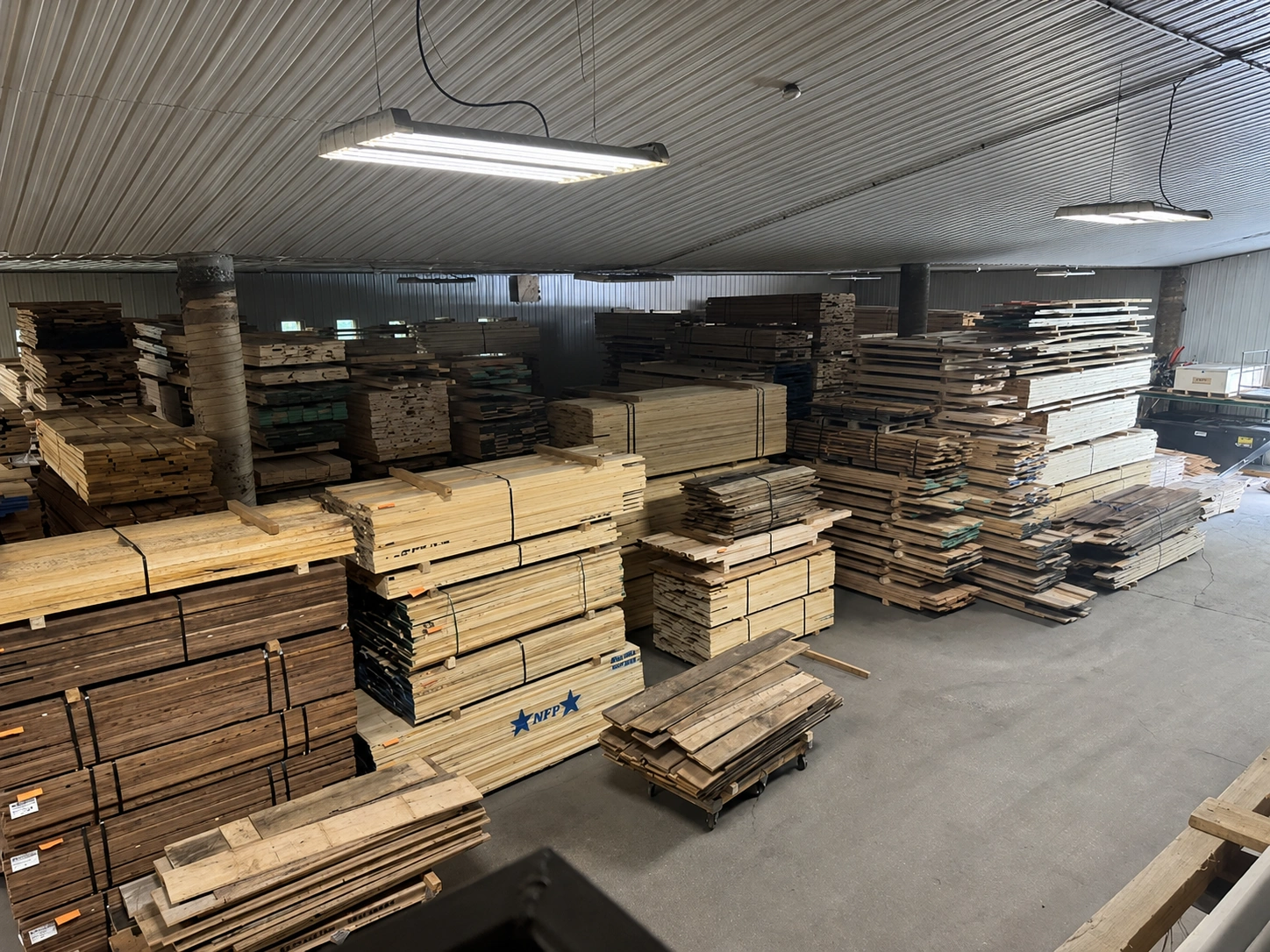 Stacks of hardwood lumber inside a warehouse
